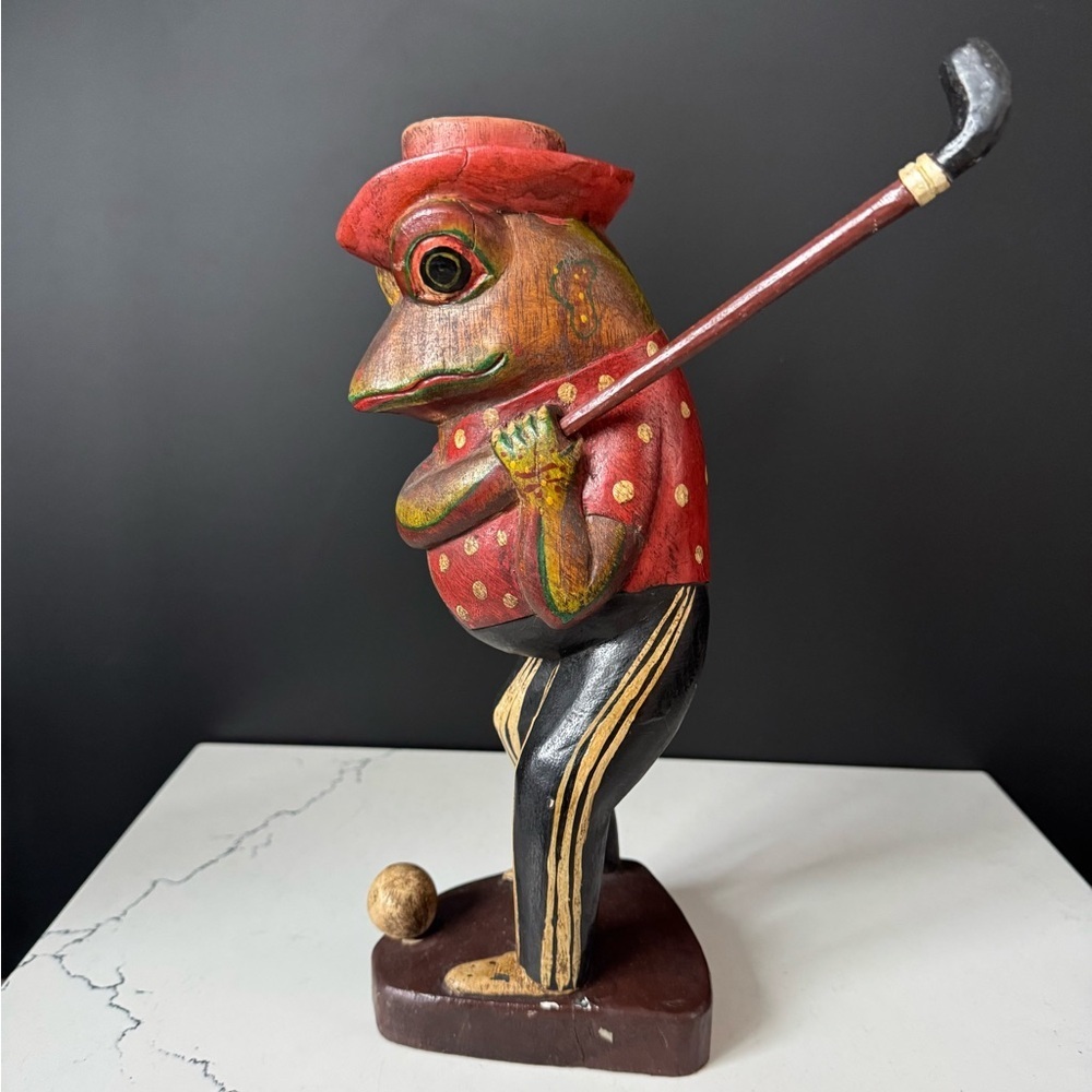Hand-carved wooden anthropomorphic frog golfer figurine